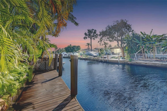 dock area featuring a water view and fence