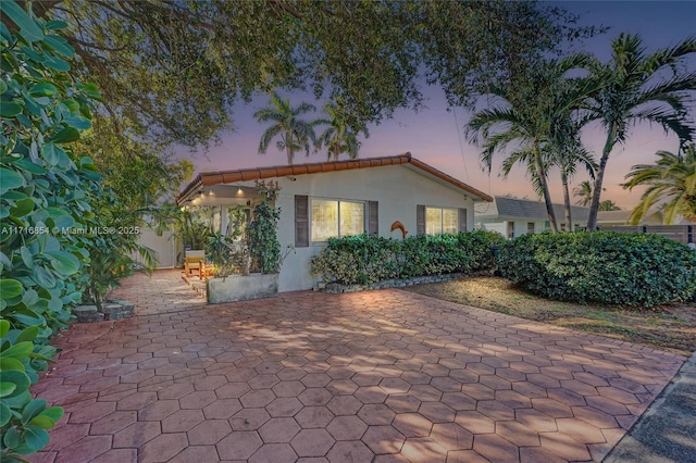 view of front of property with a patio area and stucco siding