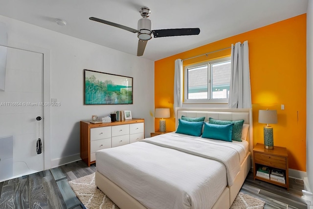 bedroom with ceiling fan and dark wood-type flooring