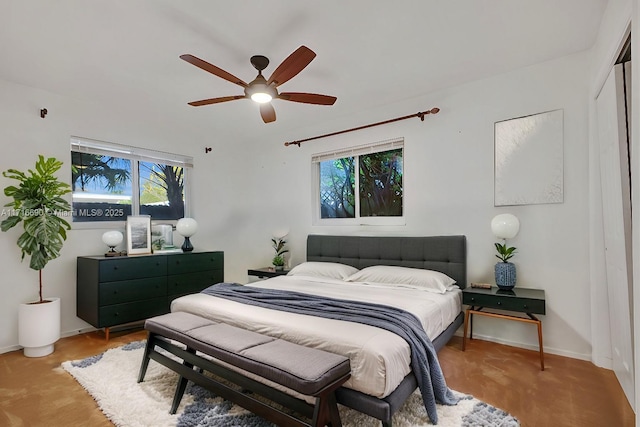 bedroom with ceiling fan and a closet