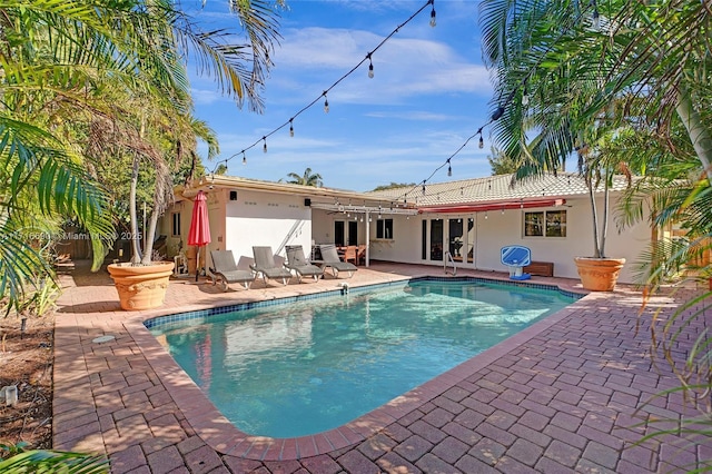 view of pool with ceiling fan and a patio area