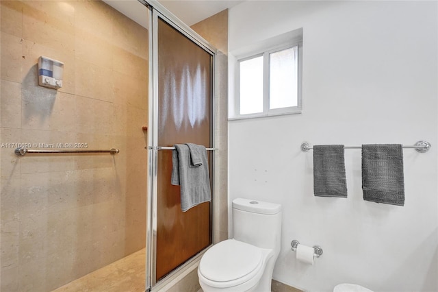 bathroom featuring an enclosed shower and toilet