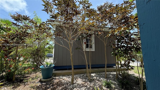 view of side of property featuring a storage unit