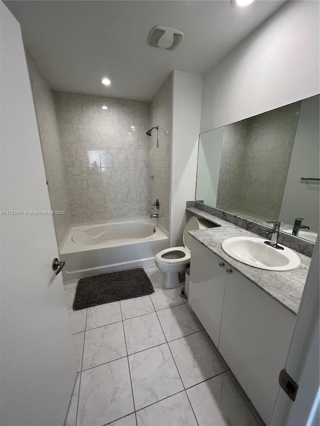 full bathroom featuring tiled shower / bath combo, toilet, and vanity