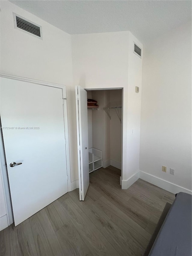 interior space featuring hardwood / wood-style flooring and a closet