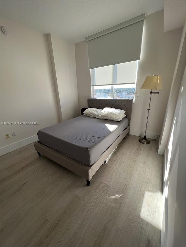 bedroom with hardwood / wood-style flooring