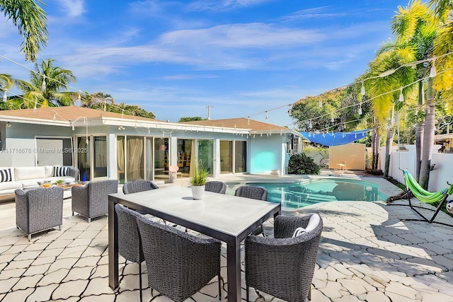 view of swimming pool with an outdoor living space, fence private yard, outdoor dining area, a patio, and a fenced in pool