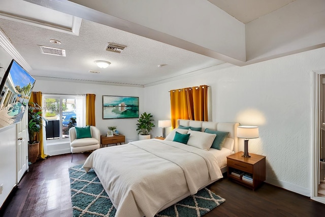 bedroom featuring dark hardwood / wood-style floors, a textured ceiling, and ornamental molding