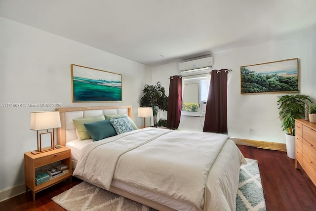 bedroom featuring dark wood-type flooring and a wall mounted air conditioner