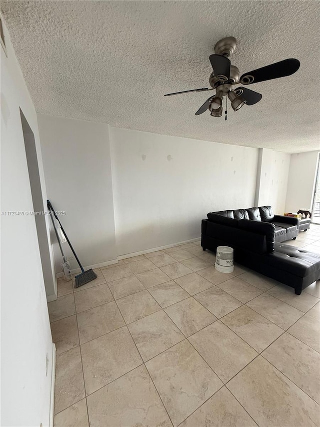 tiled living room featuring a textured ceiling and ceiling fan