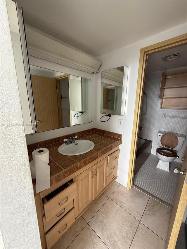 bathroom with tile patterned floors, vanity, and toilet