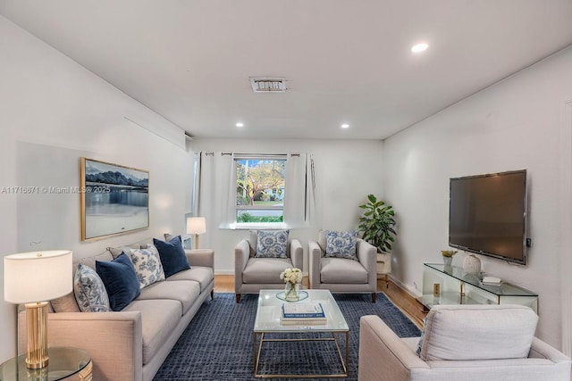 living area featuring recessed lighting, wood finished floors, and baseboards