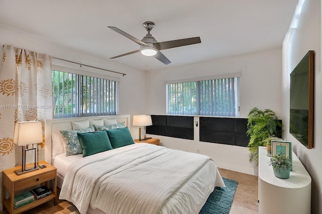 bedroom featuring multiple windows, a ceiling fan, and tile patterned flooring