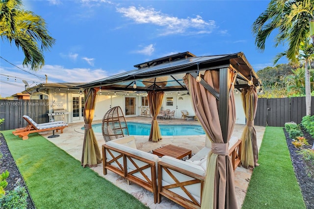 view of pool featuring a fenced in pool, a fenced backyard, and a patio area