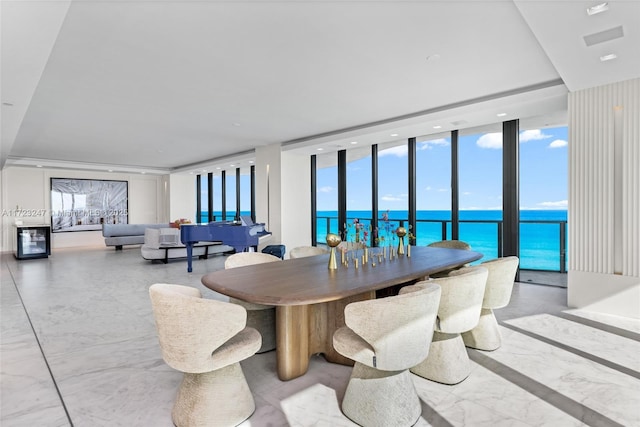 dining space with a water view and expansive windows