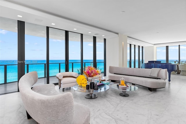 living room with floor to ceiling windows, a wealth of natural light, and a water view