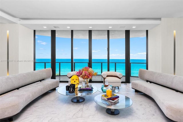 living room featuring a water view and floor to ceiling windows