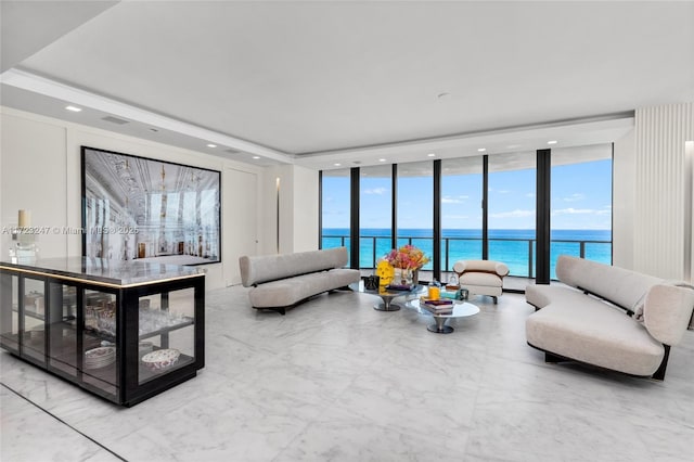 living room featuring a water view and a wall of windows