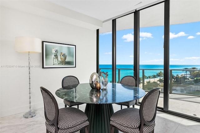 dining room with a water view and expansive windows