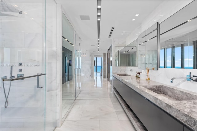 bathroom with plenty of natural light, vanity, and walk in shower