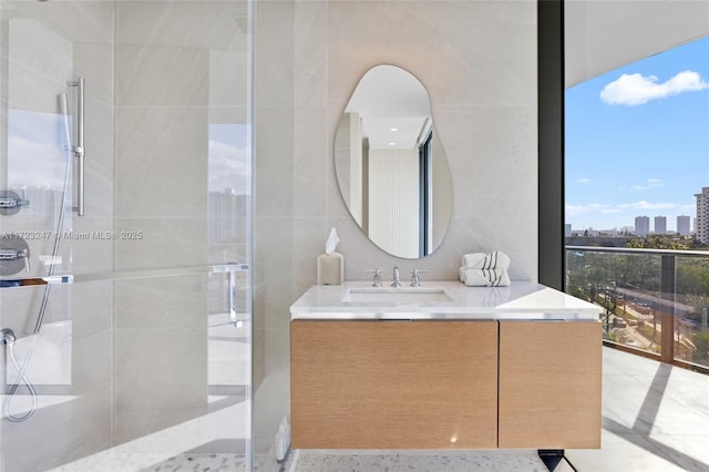 bathroom featuring vanity and a shower with shower door