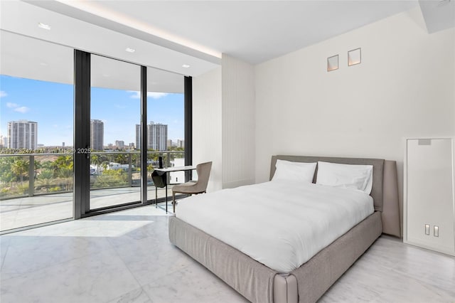 bedroom featuring access to exterior and floor to ceiling windows