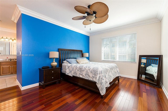 bedroom featuring ceiling fan, ornamental molding, dark wood-type flooring, and ensuite bath