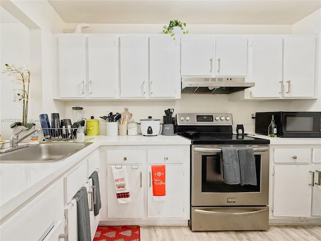 kitchen featuring white cabinetry, sink, and stainless steel electric range