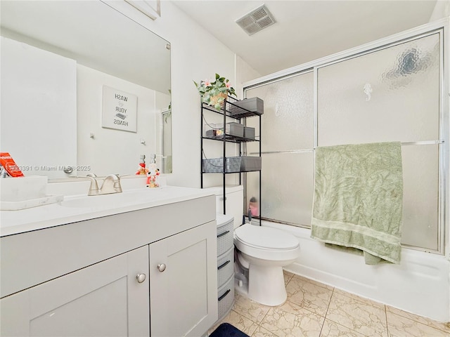 full bathroom featuring shower / bath combination with glass door, vanity, and toilet