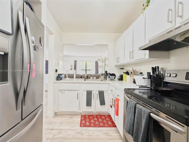 kitchen featuring light wood-type flooring, stainless steel appliances, white cabinetry, and sink