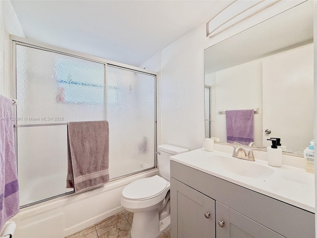 full bathroom with tile patterned floors, vanity, toilet, and enclosed tub / shower combo