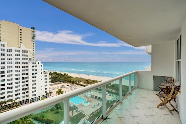 balcony with a water view and a beach view