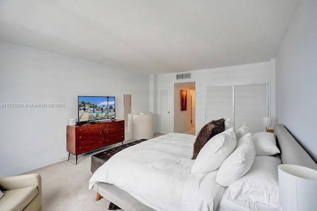 bedroom with light carpet and a closet