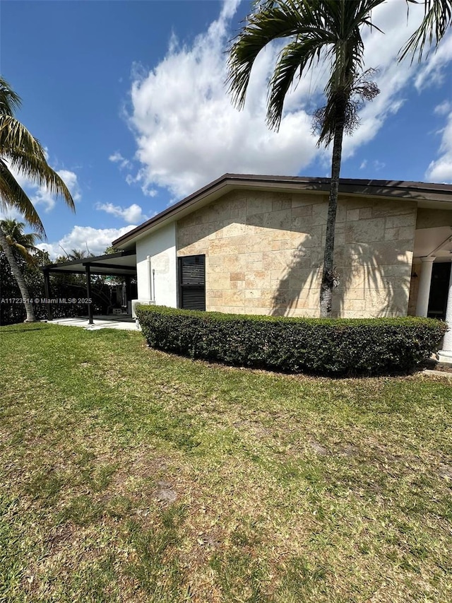 view of property exterior with a carport and a lawn