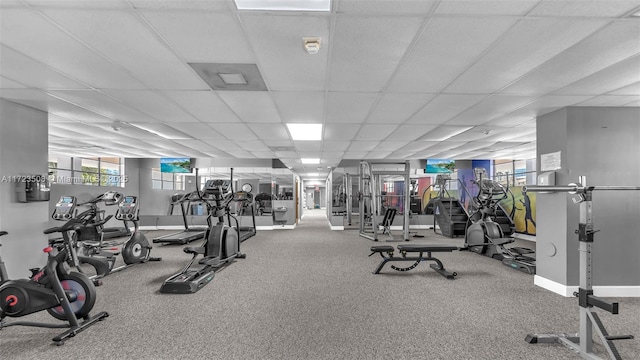 workout area with baseboards and a drop ceiling