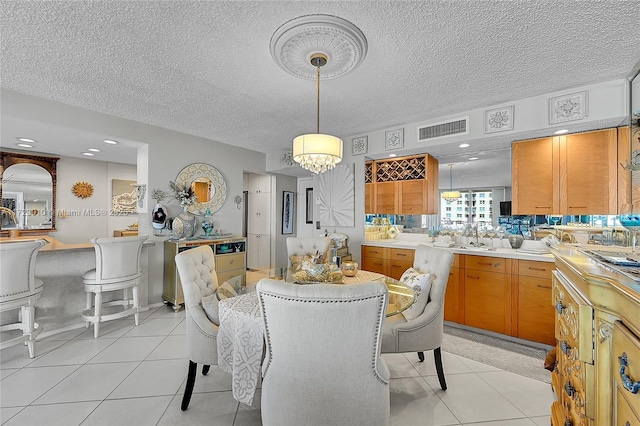 dining space with light tile patterned flooring, a textured ceiling, and an inviting chandelier