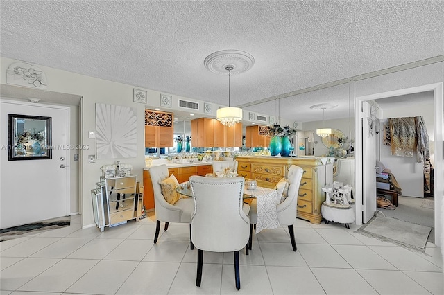 dining room with light tile patterned floors, a textured ceiling, and an inviting chandelier