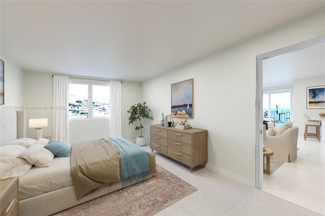 bedroom featuring light colored carpet and ensuite bath