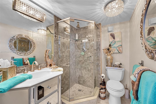 bathroom with a chandelier, vanity, toilet, and walk in shower