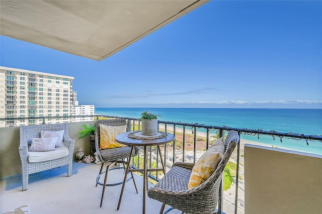 balcony with a water view and a beach view