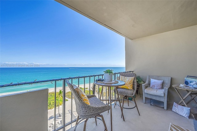 balcony with a water view and a beach view