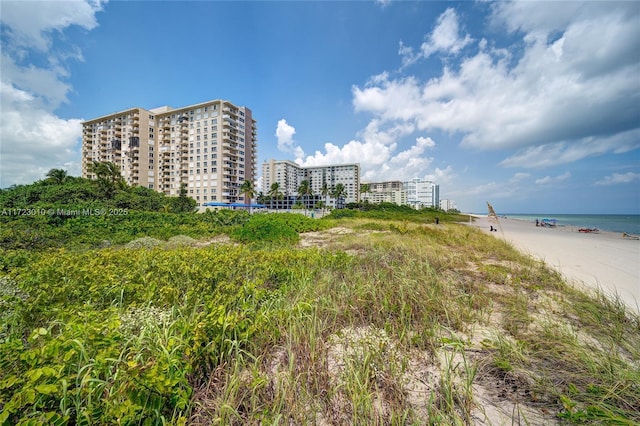 exterior space with a water view and a beach view