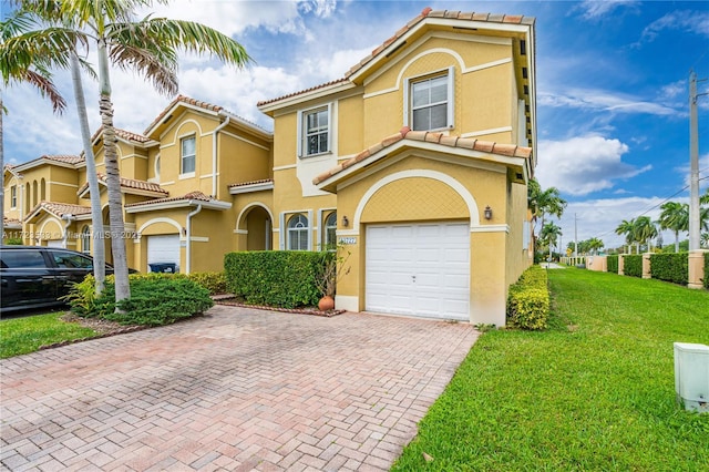 view of front of property with a garage and a front lawn