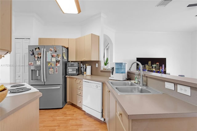 kitchen featuring kitchen peninsula, stainless steel fridge, sink, light brown cabinets, and dishwasher