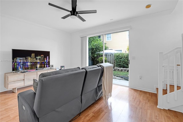 living room featuring ceiling fan and hardwood / wood-style flooring