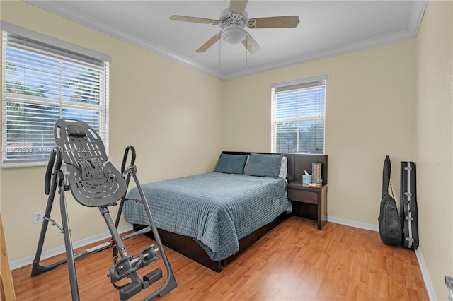 bedroom featuring hardwood / wood-style flooring, ceiling fan, and ornamental molding