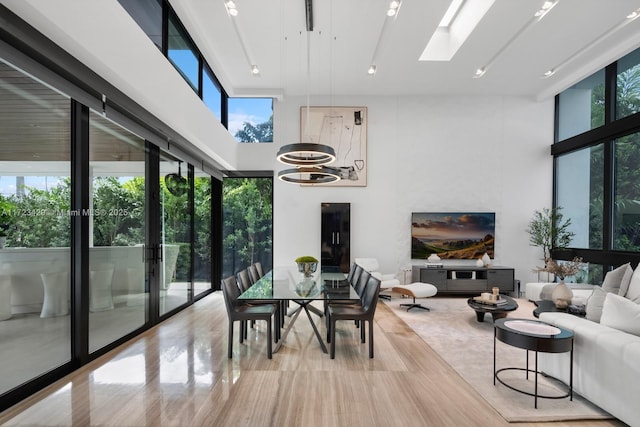 sunroom featuring a chandelier and a skylight