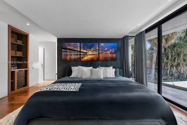 bedroom featuring access to outside and light wood-type flooring