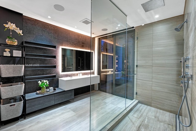 bathroom featuring vanity, tile walls, and an enclosed shower