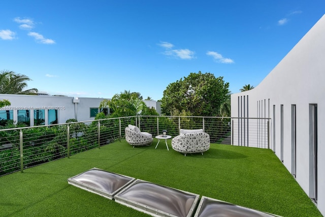 view of yard with a balcony